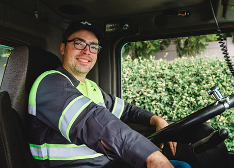 man truck driver cab safety vest hat