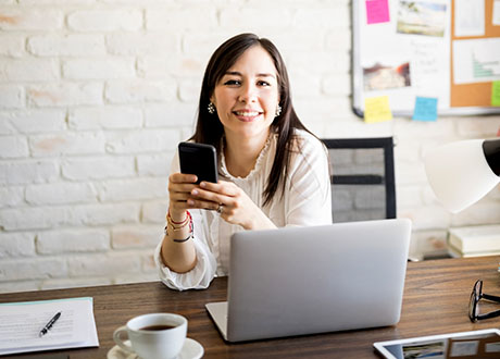 office desk woman phone laptop